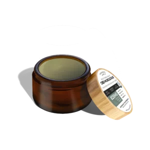 An open jar of a CBD Muscle Rub, also known as a CBD salve, shows the balm-like texture and color so viewers can have a better idea of what to expect.